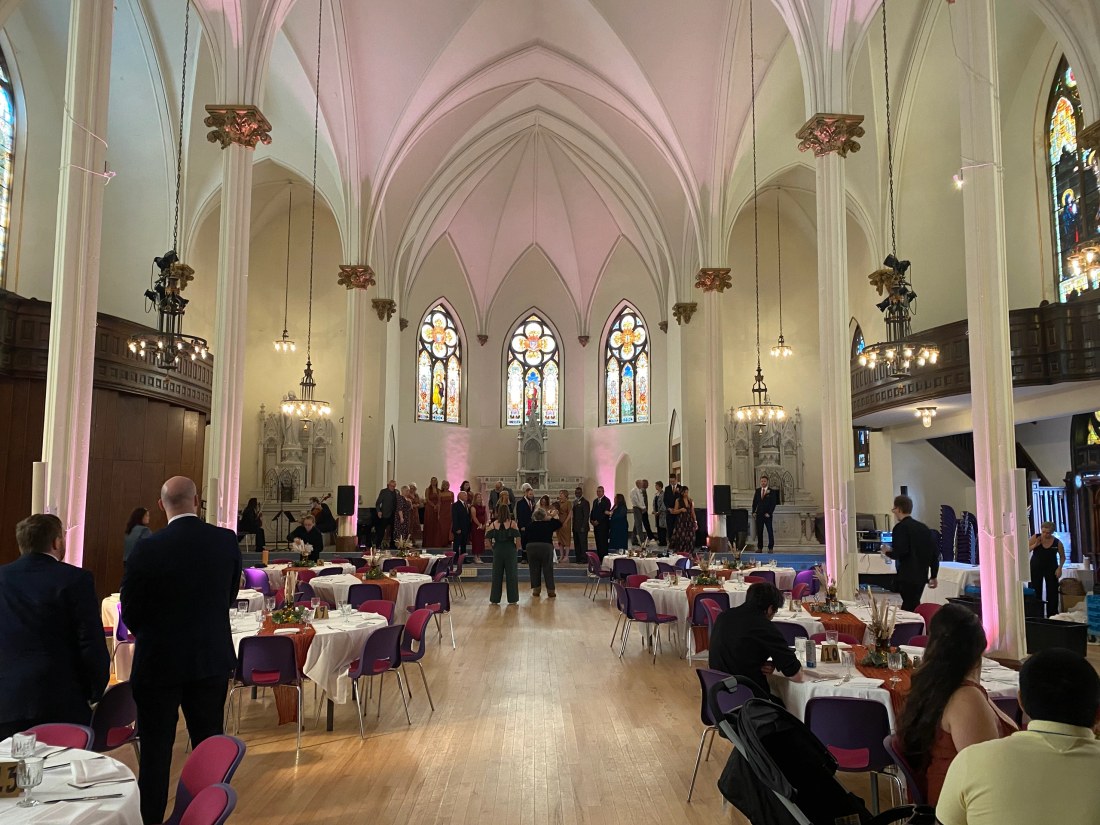 A reception space with vaulted ceilings and tables ready for guests